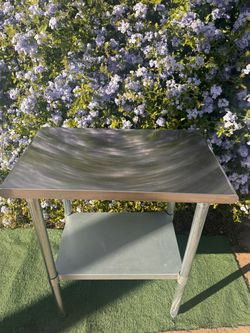 Commercial Heavy Duty Stainless Steel Prep and Work Table With Smooth Metal Top, Rounded Edges, Four Tubular Legs and Adjustable Lower Shelf
