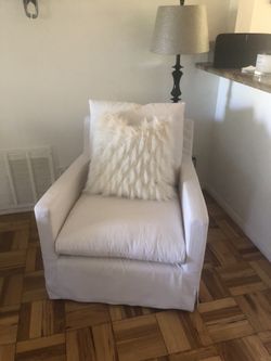 Cream colored brand slip covered swivel chair