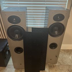 Two towers, center channel and 12 inch Polk audio subwoofer  