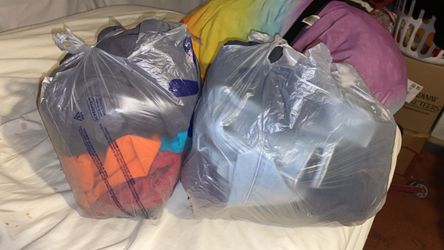 2 bags of shirts and 2 or 3 possibly Womens jeans and Mens 2XL shirts