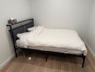 Black Metal Bed Frame with Upholstered Headboard and a mattress