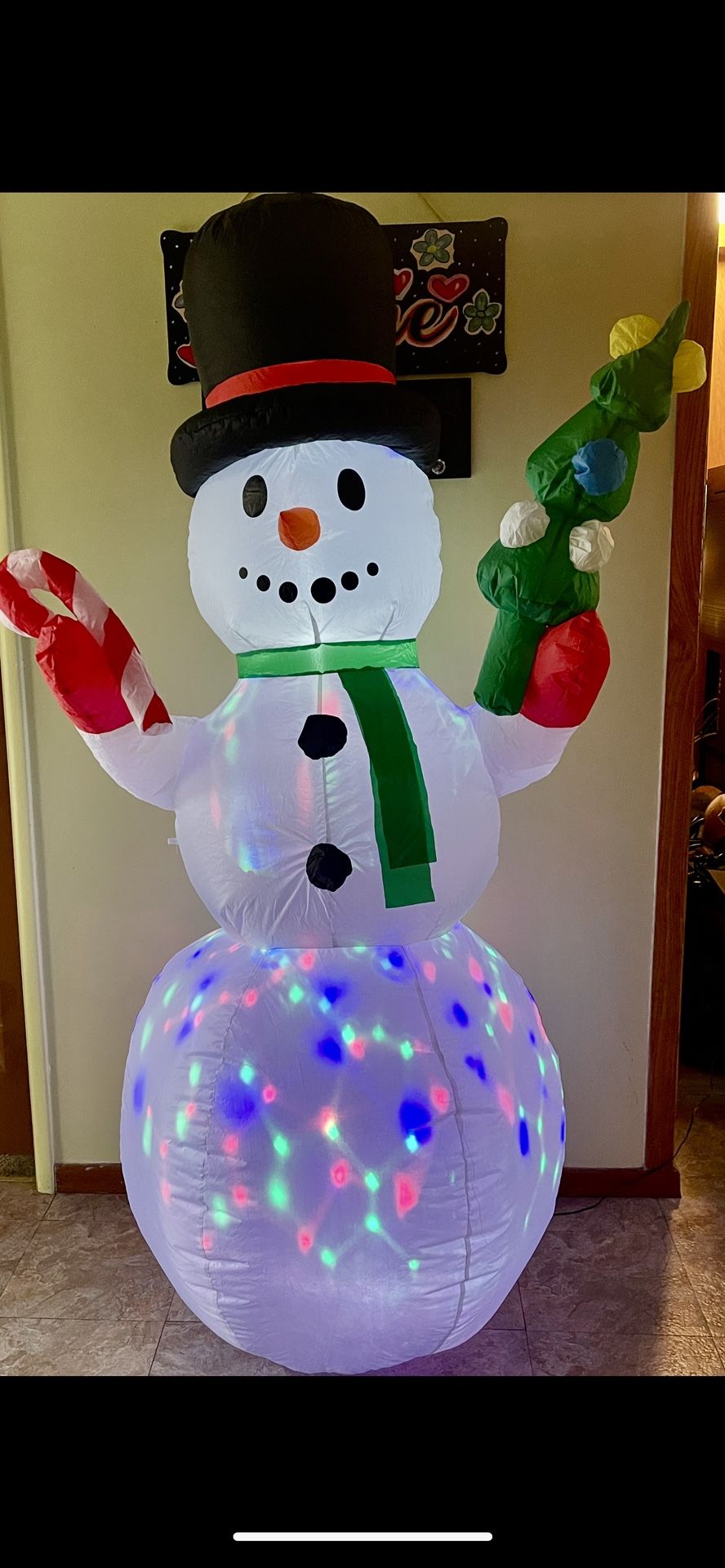 An Inflatable Light-up Snowman Christmas Yard Decoration.