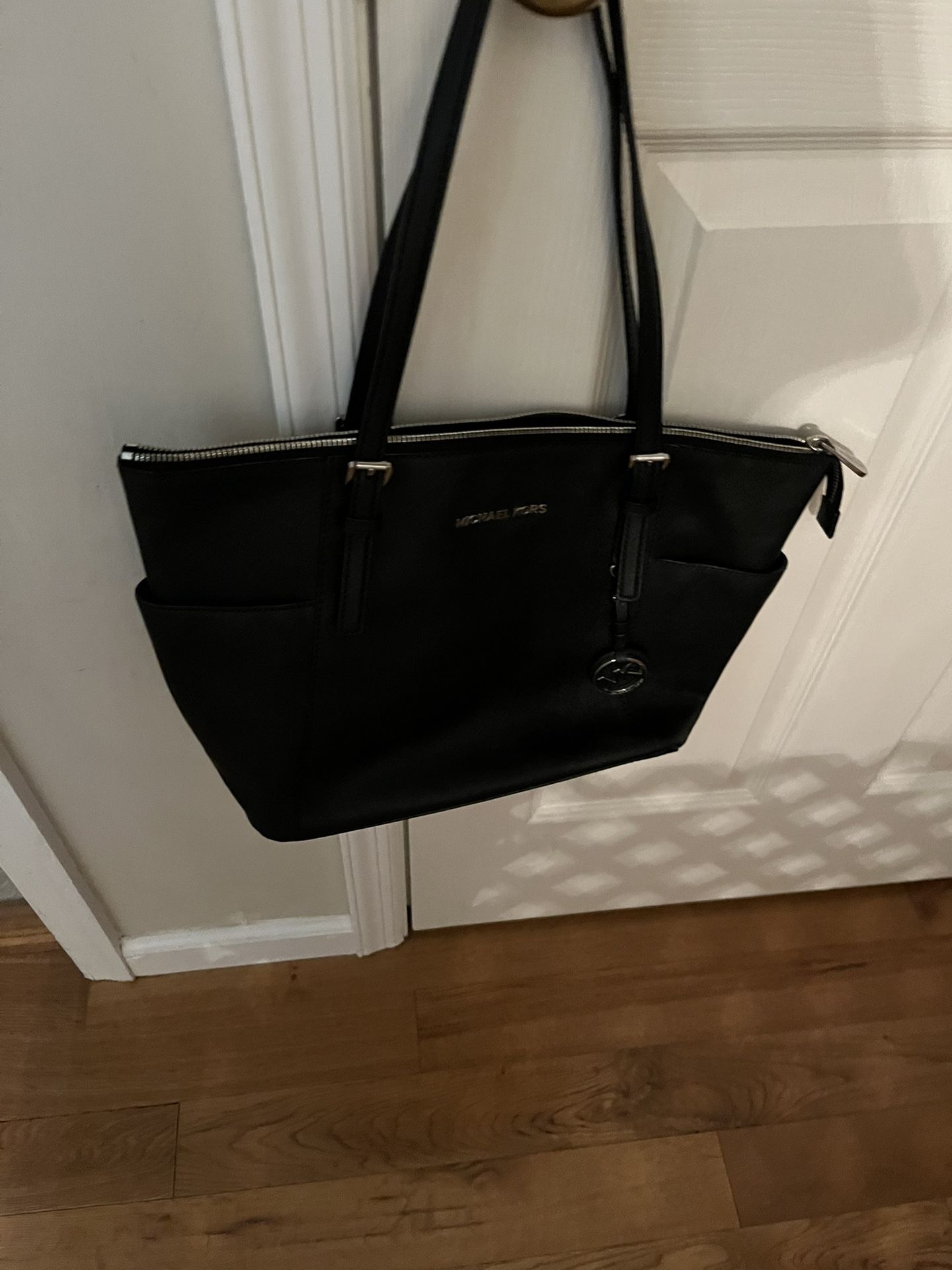 Stylish black handbag by Michael Kors.