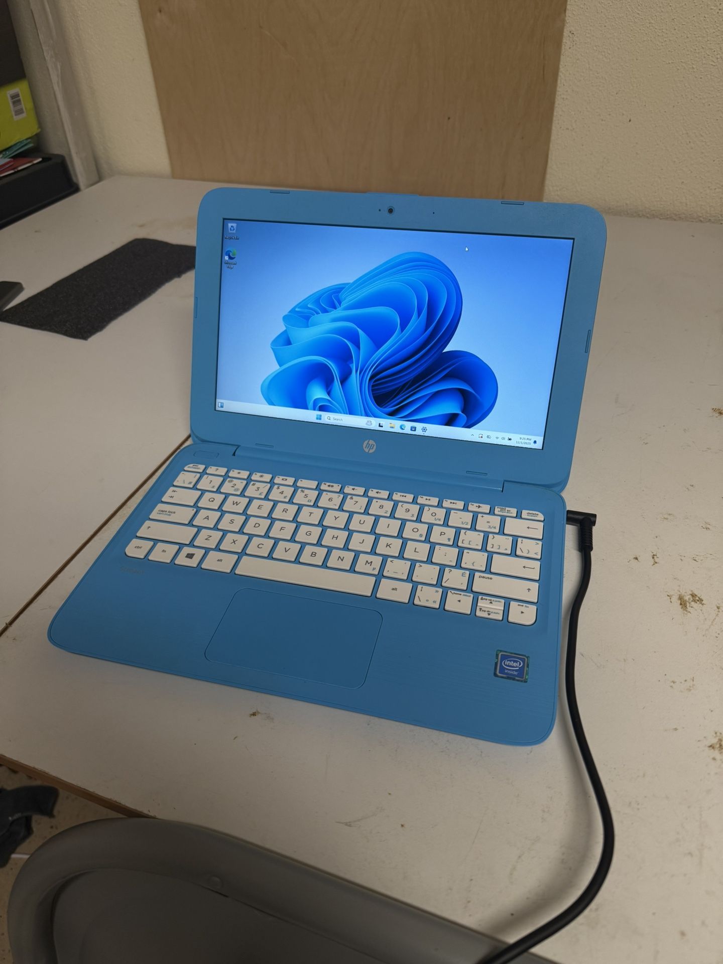 Blue-themed Windows 11 Laptop with charger