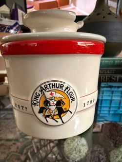 King Arthur Flour Red and White Ceramic Butter Bell Crock     Durable ceramic butter bell with a white glaze and red rim. This two-piece set has the K