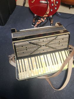 Vintage Hohner piano accordion with case and straps