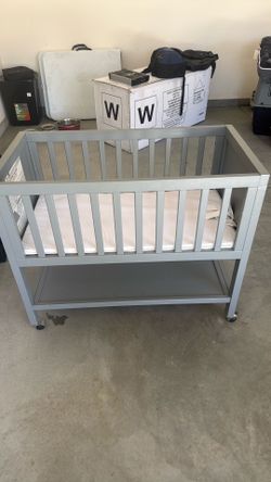 Modern gray baby bassinet with mattress