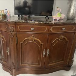 Used , I am selling a brown wooden table set with 10 chairs and a clear glass top. table 12 ft x 49x37, and buffet top marble 76x23x42