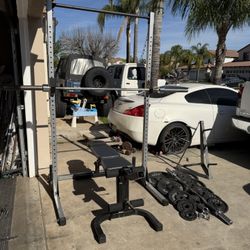 Bench press/squat rack with 7ft 45lbs bar plus 245lbs of Olympic weights with curl bar and weigh tree