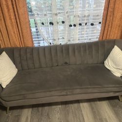 channel-tufted curved sofa