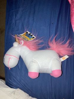 Despicable Me" Fluffy the Unicorn plush toy, likely produced by Toy https://offerup.com/redirect/?o=RmFjdG9yeS5JdA== features a white plush body, a go