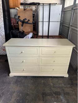 Beige wood 6- drawer lowboy dresser.  measurements 21 deep x  58L x 34H