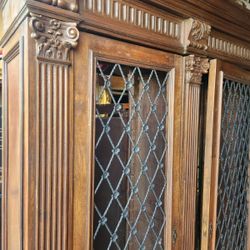 Antique Italian  bookcase hand-carved of walnut with lion paw feet