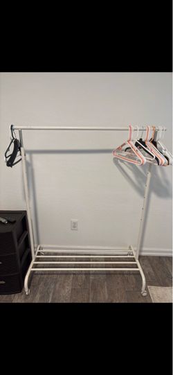 IKEA clothes rack with bottom shelf and wheels in great condition