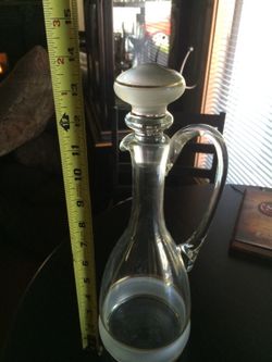 Antique glass decanter with gold accents.