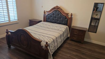 Full wooden Queen bed frame with Mattress and double dresser featuring a matching ornate arched mirror ,and  x two-drawer wooden nightstand.