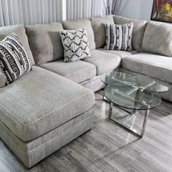 Ashley! Like new! A modern and comfortable 3-piece sectional in excellent condition—light gray, with no stains or tears. Features removable covers. An