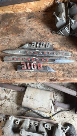 2 Chevrolet front fender side trim spears and two 3100 emblems from a mid-1950s