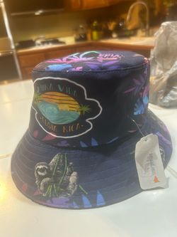 dark blue bucket hat features a "Pura Vida Costa Rica" sunset patch and tropical sloth graphics.