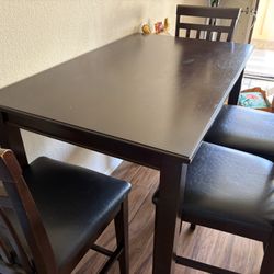 Solid Wood Dining Table w/4 leather padded chairs.