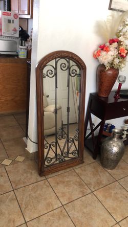 Vintage Solid Oak mirror with wrought Iron designs. Heavy 50”Height 22” Width