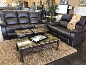 Brown leather reclining sofa and loveseat