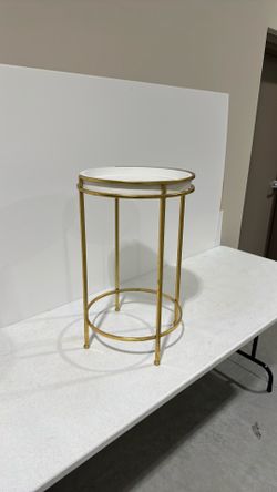 round white table with gold trim, and legs