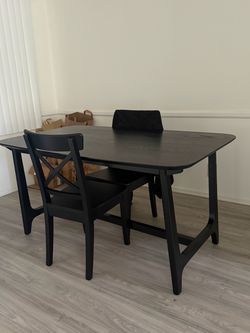 black dinner table and chairs