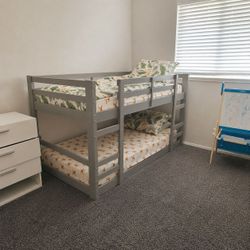 Gray bunk beds with mattresses
