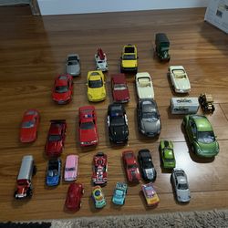 Assorted toy cars in various colors and models. 15 cars with open doors like new and 13 mini cars