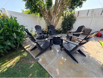 5 black Adirondack chairs