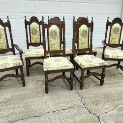 Vintage Dining Chairs Set of 7 Renaissance-Style or Spanish Revival Carved chairs, likely dating from the early 20th century.