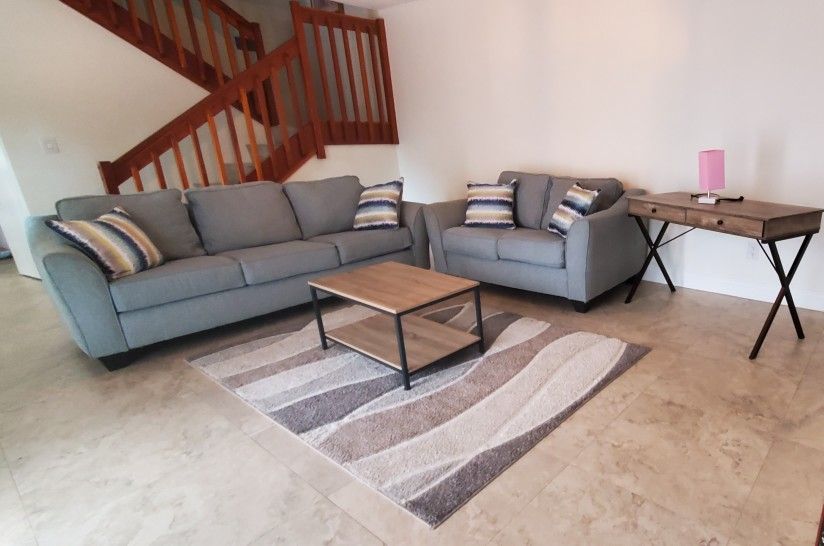 Two Clean Couch, King Size Bed ,TV Stand and Coffee table and Living Room Table