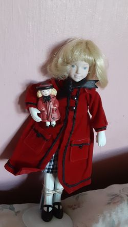 Madeline porcelain Doll holding a doll in her arms