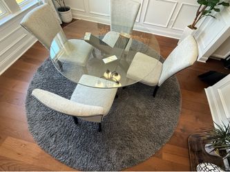 Glass Top Dining Table with 4 Gray Upholstered Chairs and dark grey shag rug
