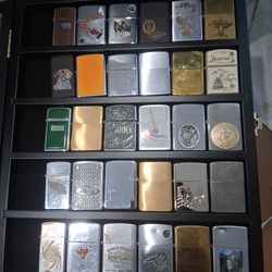 60 Zippo Lighters in 2 glass cases