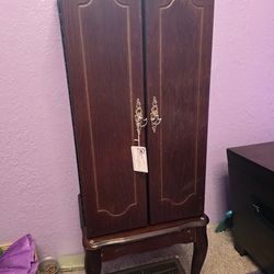Modern upright mahogany jewelry cabinet with flip top