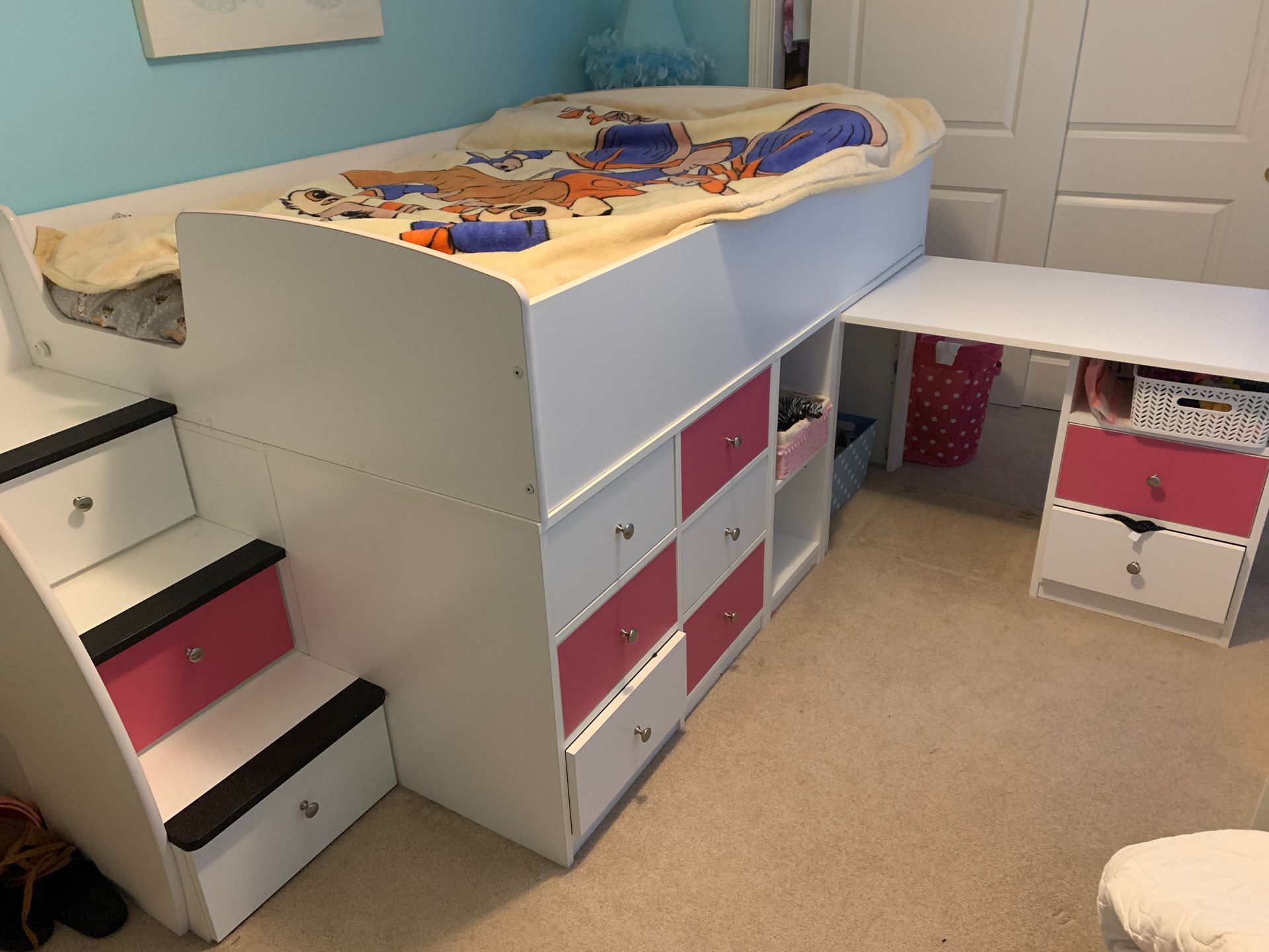 Pink and white full sized loft bed with pull out desk and storage drawers