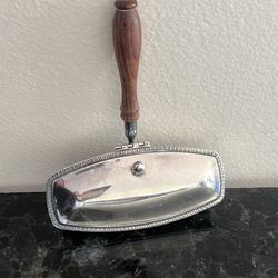 vintage Raimond silverplate silent butler, also known as a crumb catcher, used for discreetly collecting crumbs and ashes during meals.  Function: It 