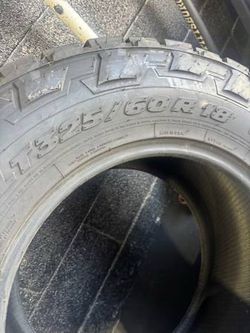 The Nitto Recon Grappler A/T in size LT325/60R18 is a hybrid all-terrain/mud-terrain light truck tire. It offers an aggressive tread block design for 