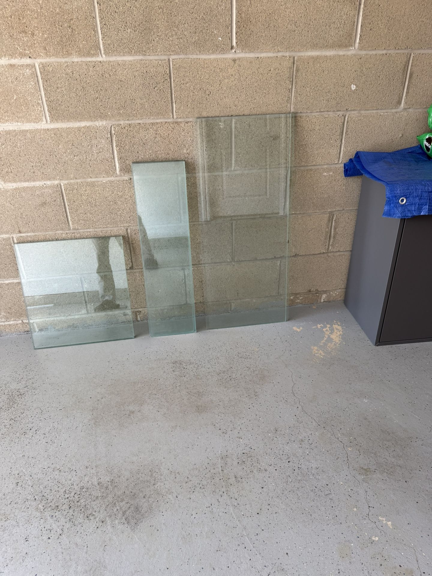 Glass. 2 sheets: 18.5”x17”x3/8”. $95x2=$190. 2 sheets: 35.5”x15”x1/8”. $80x2=$160. 4 sheets: 29.75”x8.25”x1/8”. $60x4=$240. I have the fifth sheet w
