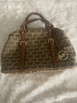 Michael Kors  bag featuring a signature MK logo print on a canvas