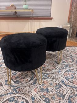 two black/gold stools for sitting