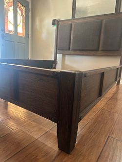 Ashley’s furniture Dark Wood Bed Frame with Upholstered Headboard