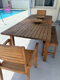 Patio table with two chairs and bench