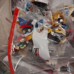 16 BAGS WITH LEGOS AND SOME PEOPLE