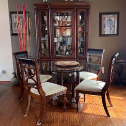 dining room with showcase with light, glass table and 4 chairs used in good condition...!!