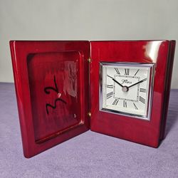 Seth Thomas travel alarm clock with a red wood case
