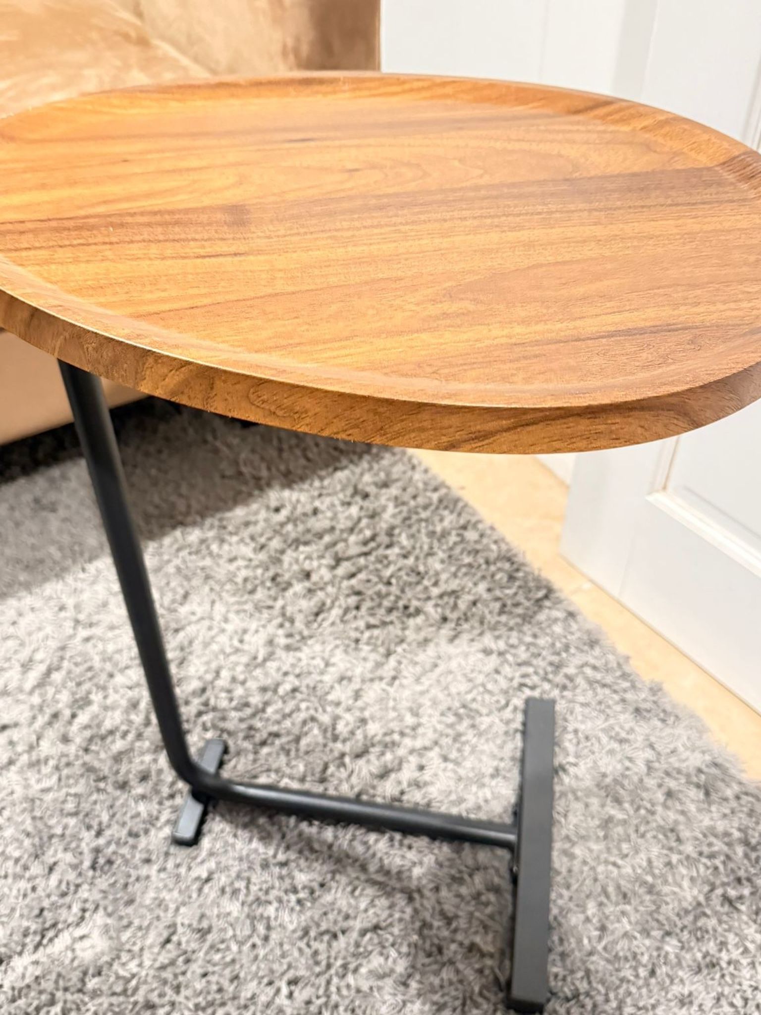 Selling a stylish side table with a wooden top and a black metal