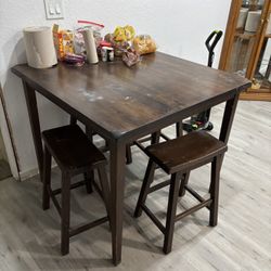 4 Stools And A Table 